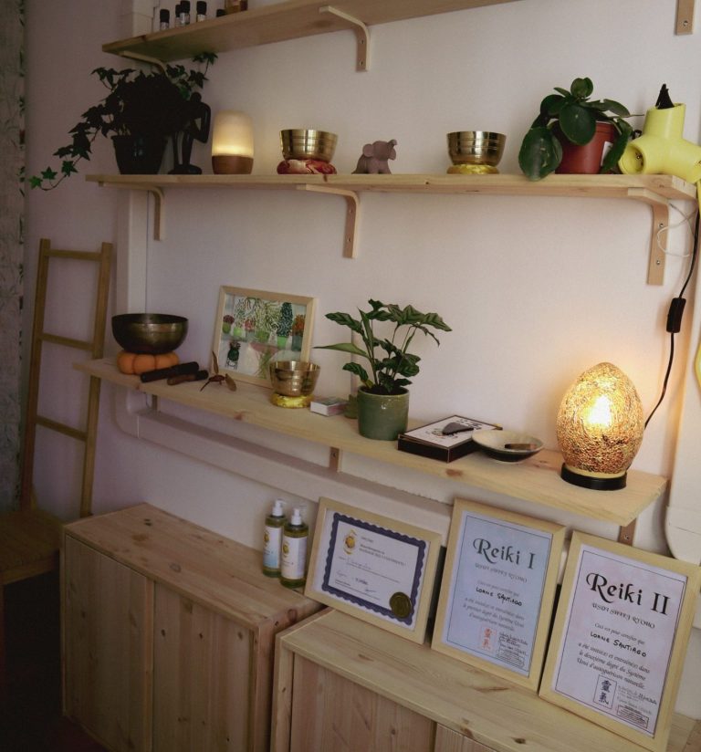 Étagères en bois avec plantes, lampes et certificats décoratifs. Ambiance chaleureuse.